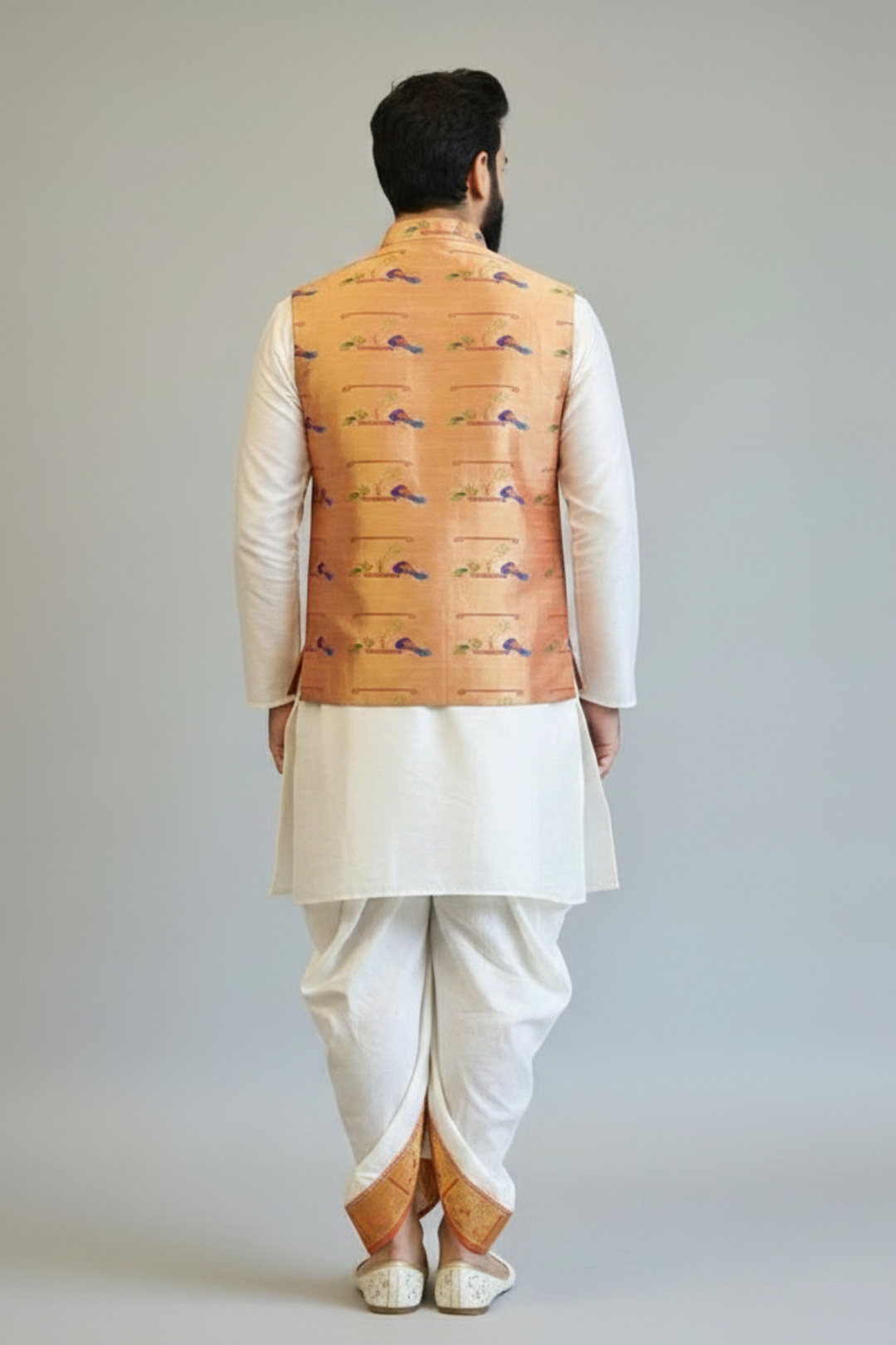 Man wearing a traditional outfit with a embroidered vest on a plain background