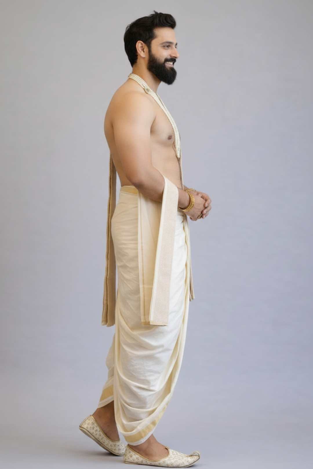 Man wearing a white dhoti with a plain background
