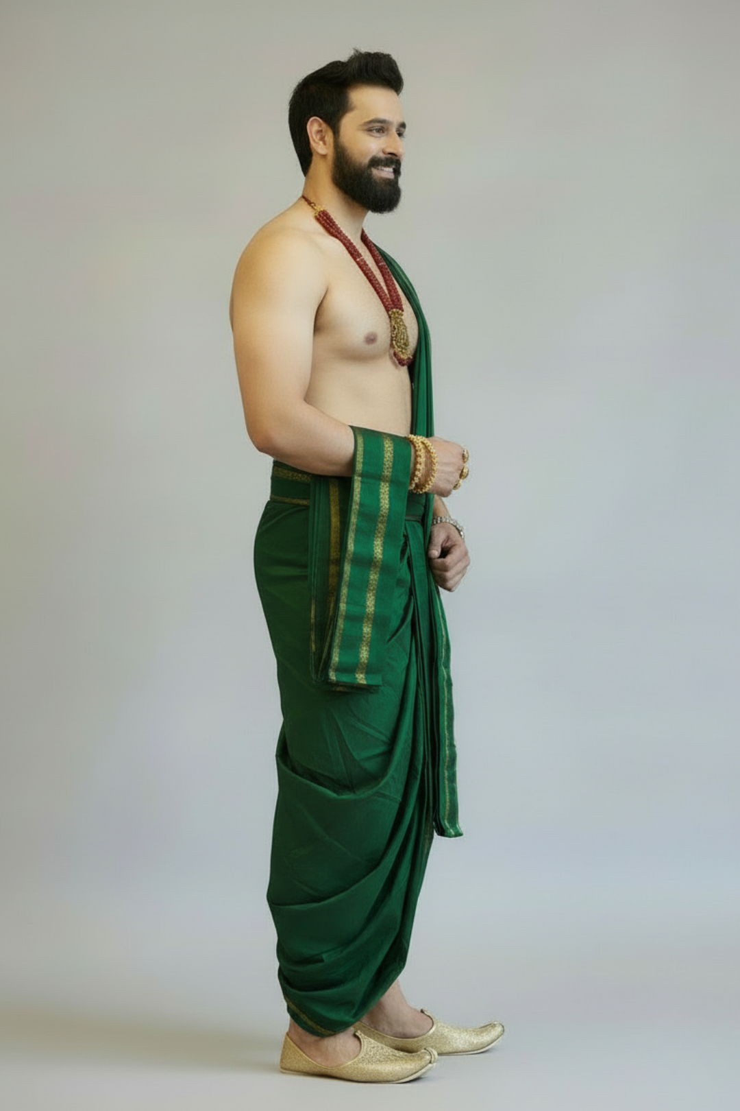 Man wearing a green dhoti with a white background