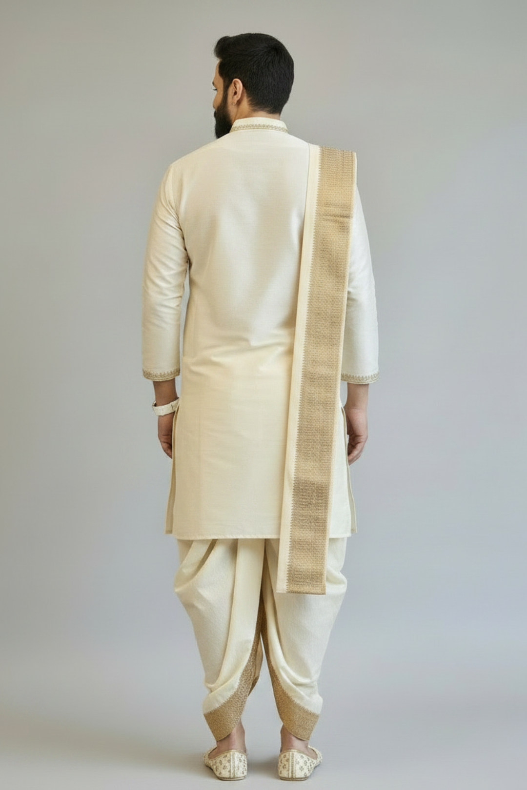 Man wearing a traditional cream kurta with a white background