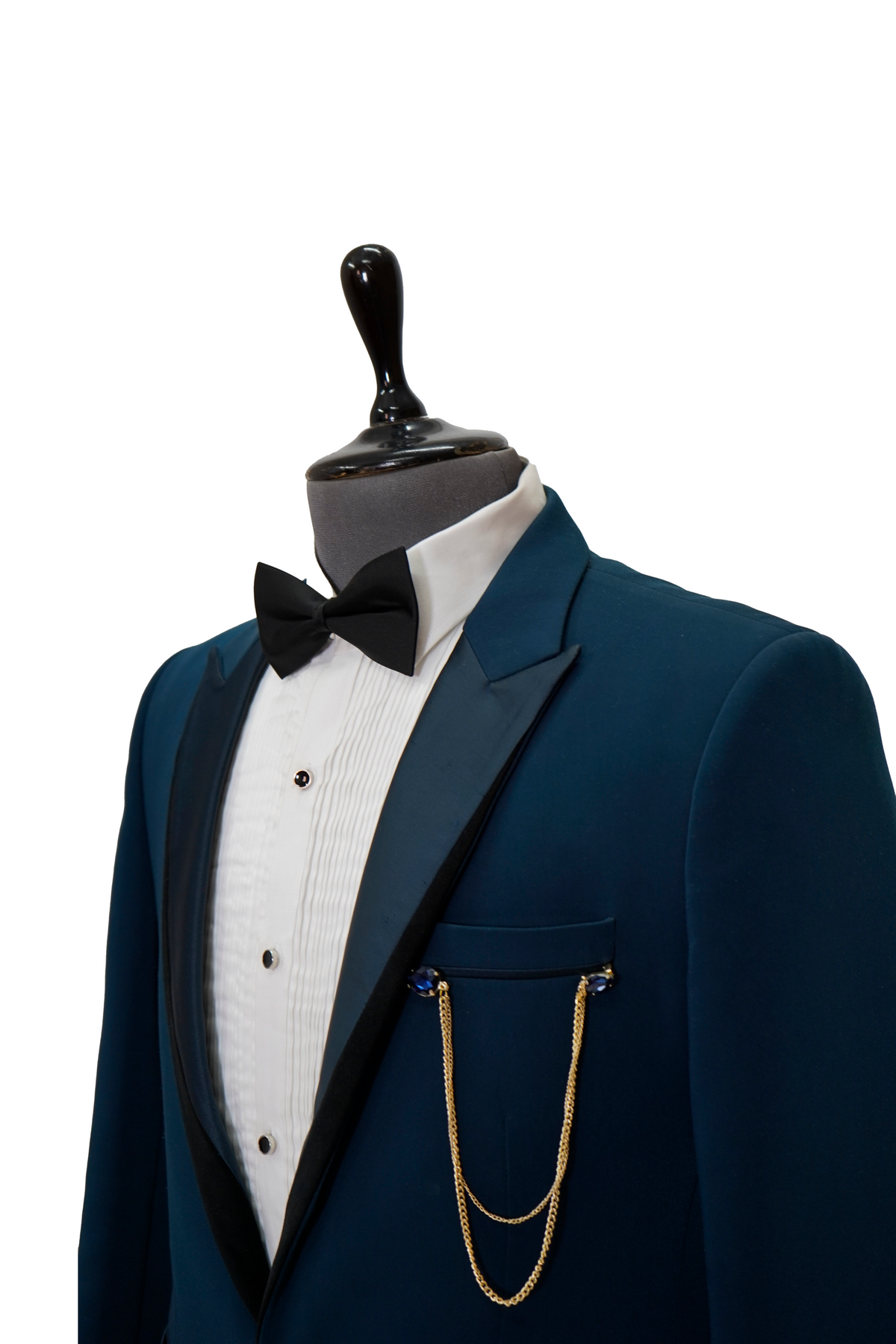 Man in a teal suit sitting on a wooden stool against a plain background
