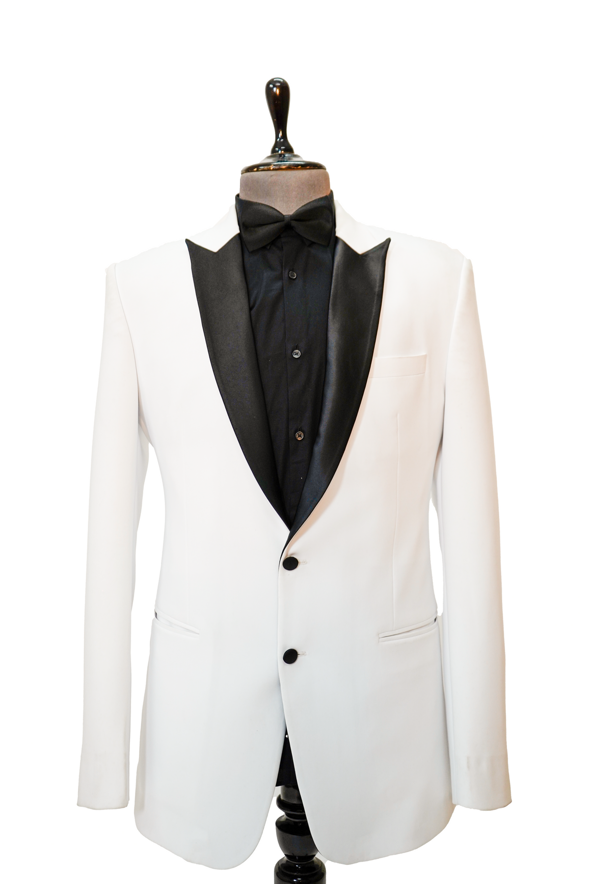 A classic white two-piece tuxedo with a black peak lapel displayed on a mannequin.