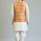 Man wearing a traditional outfit with a embroidered vest on a plain background