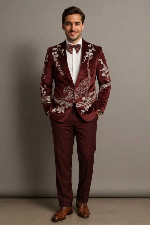 Man wearing a burgundy suit with intricate patterns against a plain background