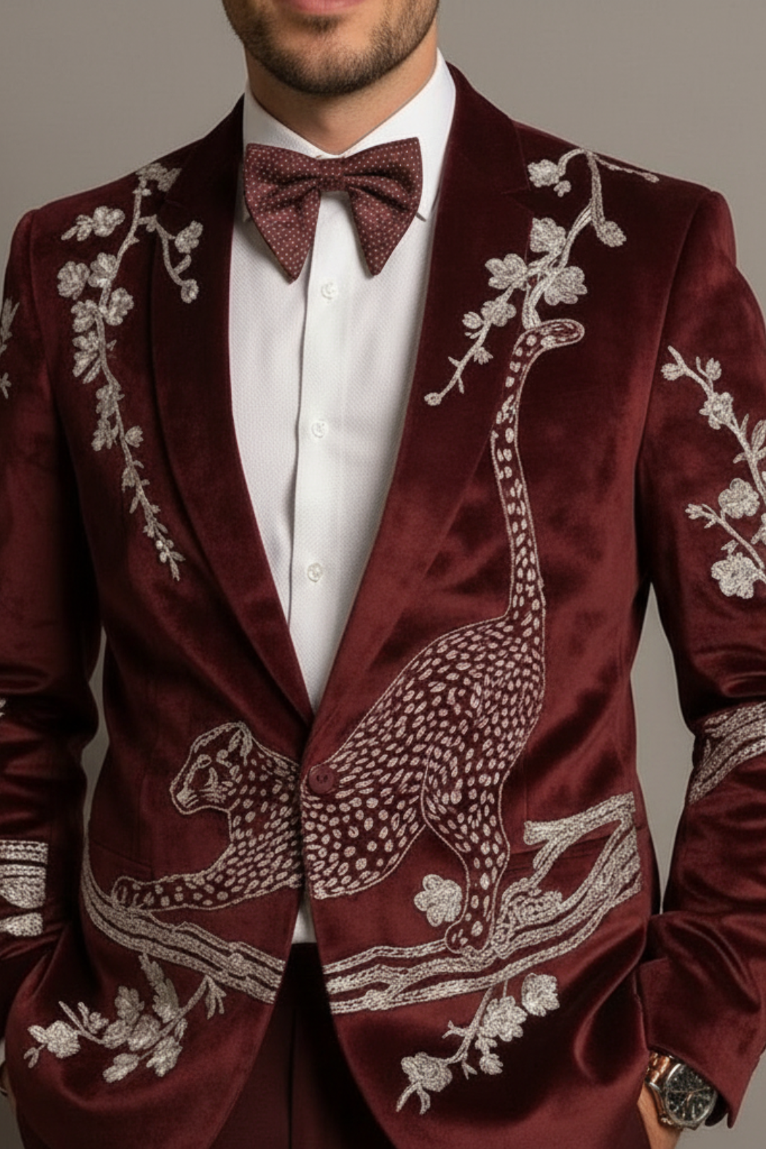 Maroon velvet suit with intricate white embroidery on a neutral background