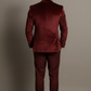 Man wearing a burgundy velvet suit against a plain background