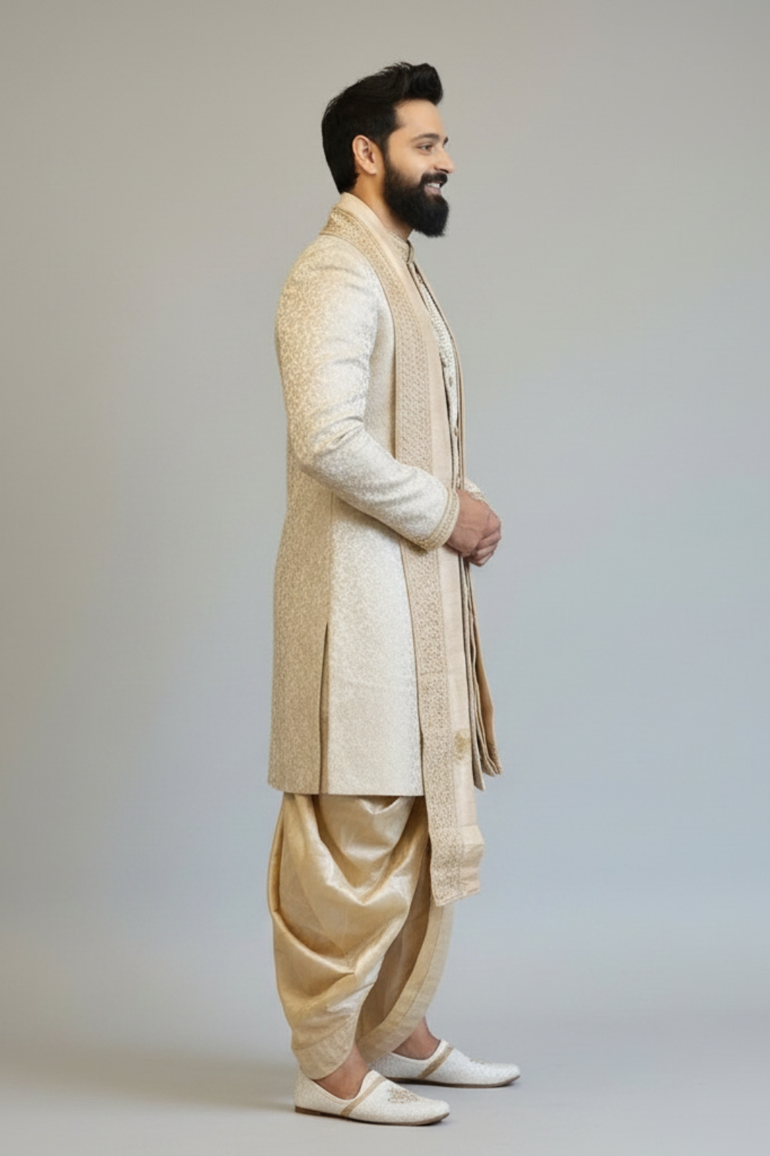 Man wearing a traditional beige kurta with a white vest on a plain background