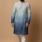 Man wearing a blue gradient kurta with white pants on a beige background
