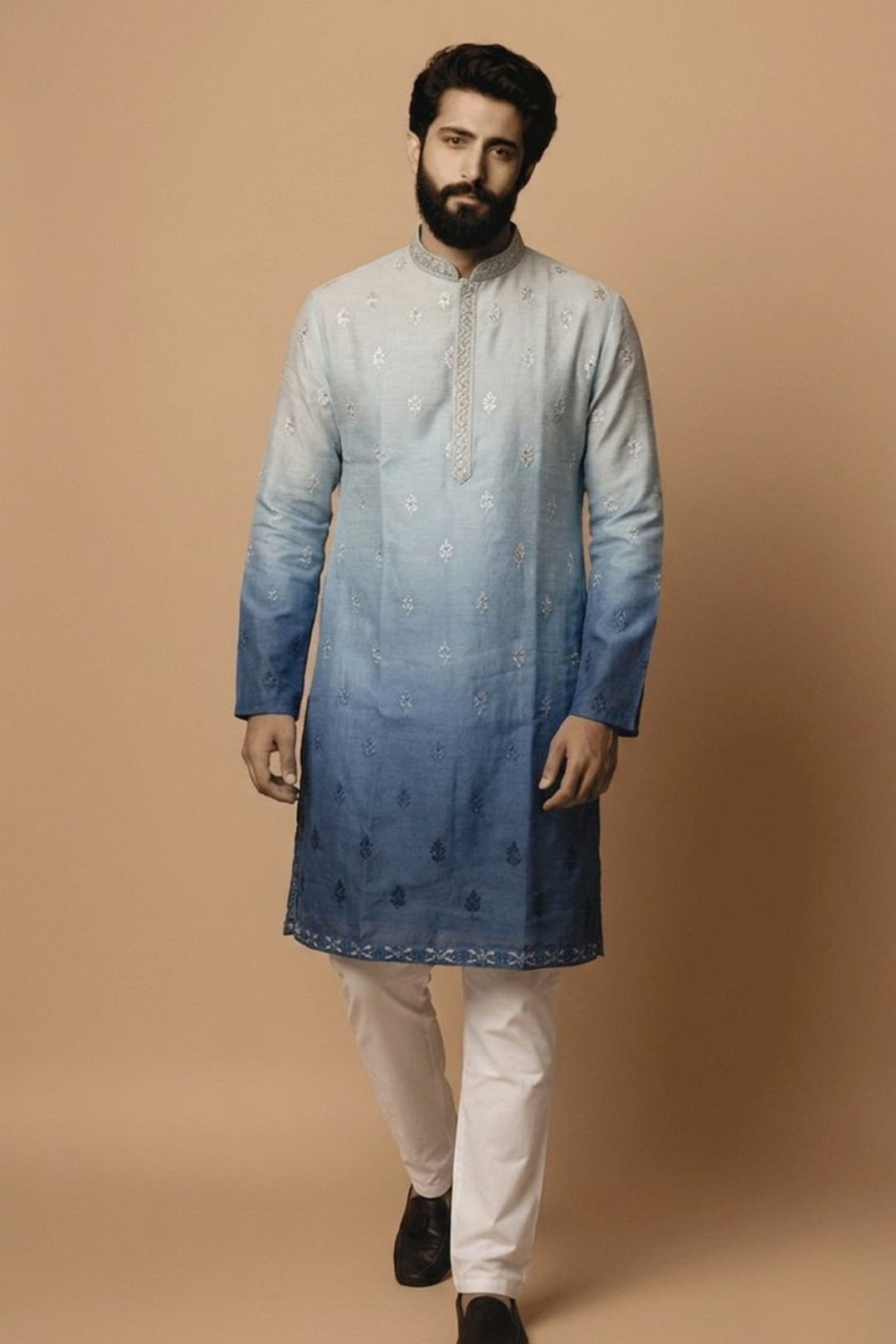 Man wearing a blue gradient kurta with white pants on a beige background