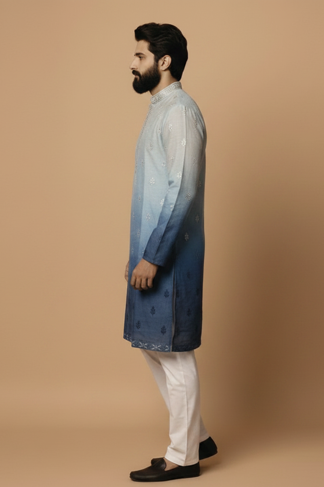 Man wearing a blue and white gradient kurta with white pants on a beige background