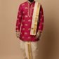 Man wearing a traditional pink kurta with gold embroidery and white dhoti on a beige background