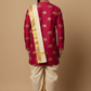Man wearing a traditional pink kurta with elephant patterns and white dhoti on a beige background