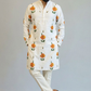 Man wearing a white kurta with floral patterns on a plain background