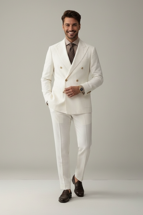 Man wearing a white suit with gold buttons on a plain background