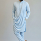 Man wearing a light blue kurta with a drape on a gray background