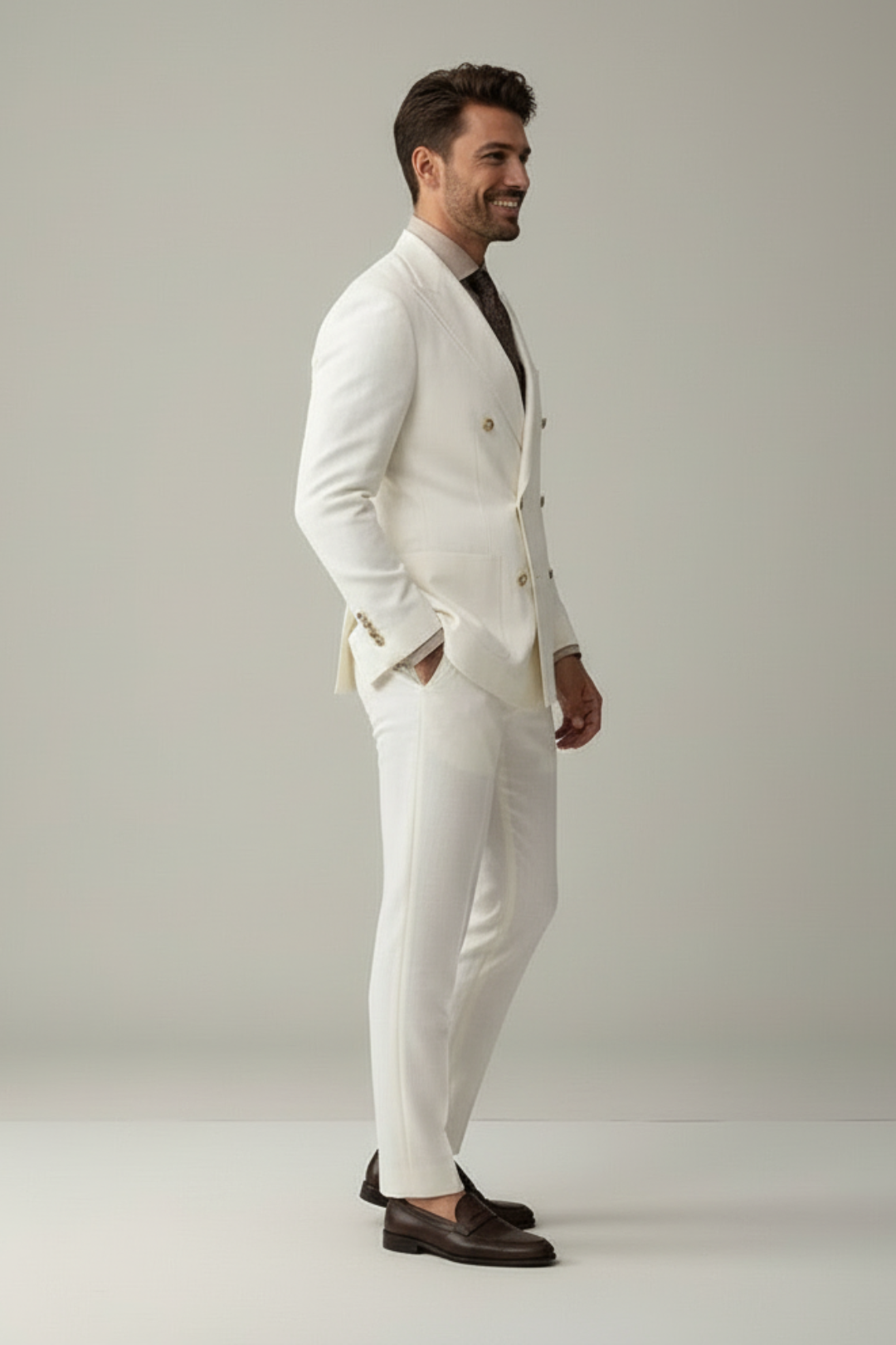 Man wearing a white suit with a gray background