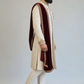 Man wearing a traditional sherwani with a maroon shawl on a plain background