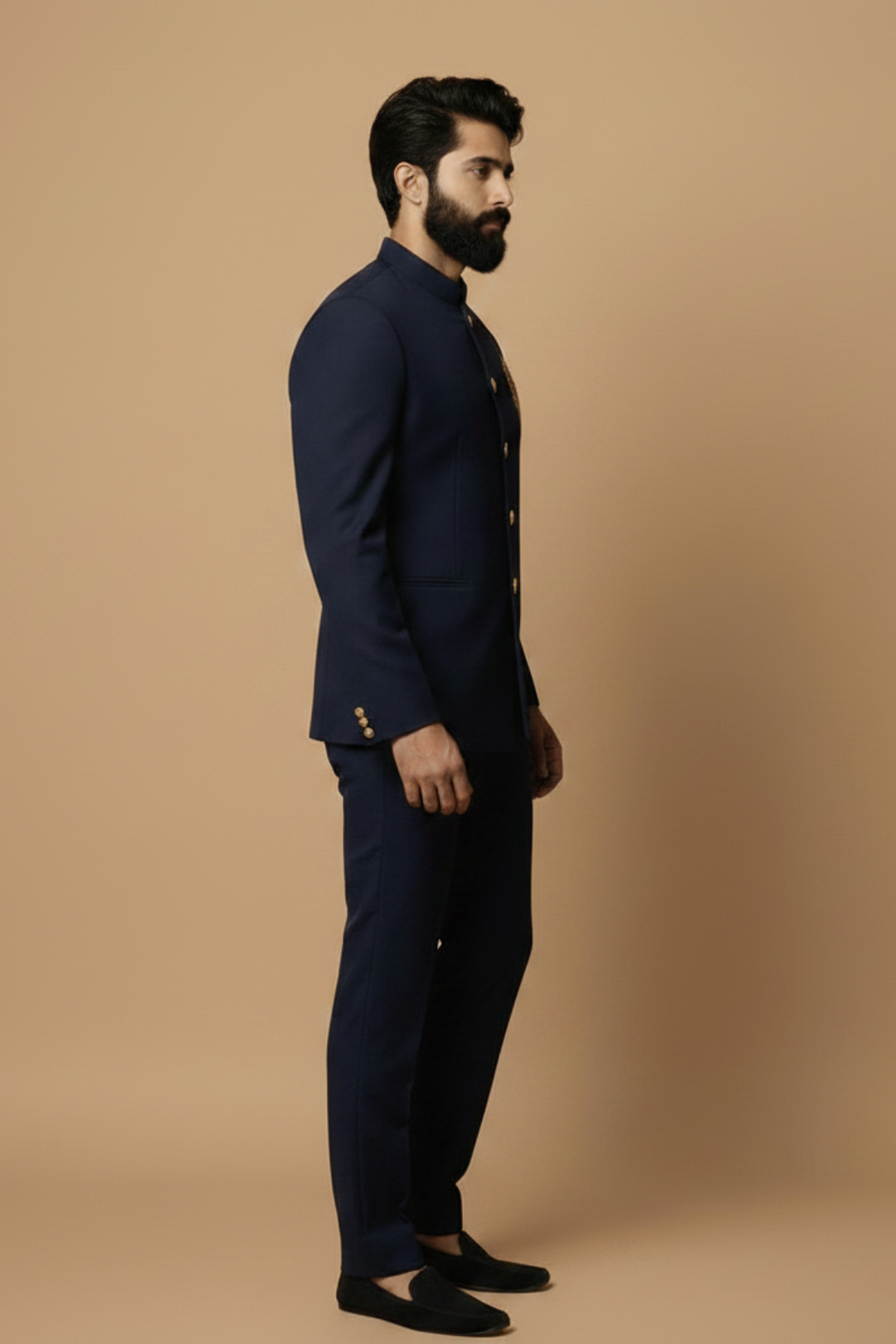 Man wearing a navy blue suit against a beige background