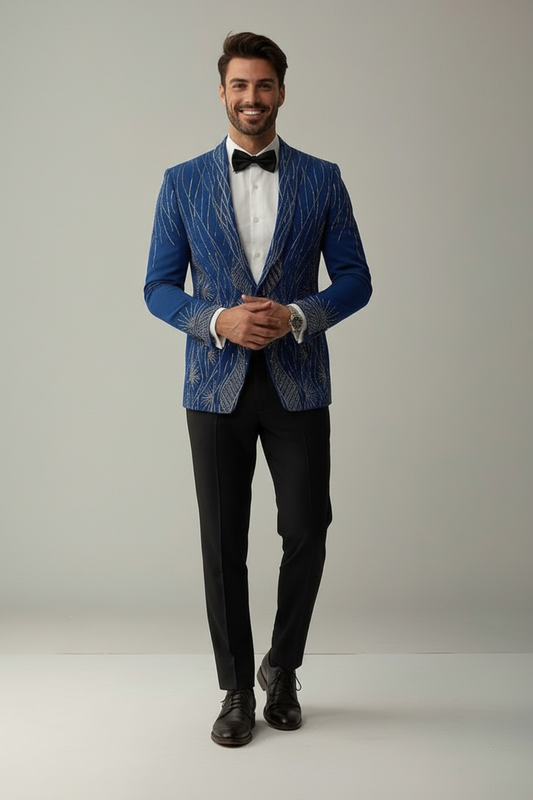Man wearing a blue patterned blazer, white shirt, black bow tie, and black pants on a plain background