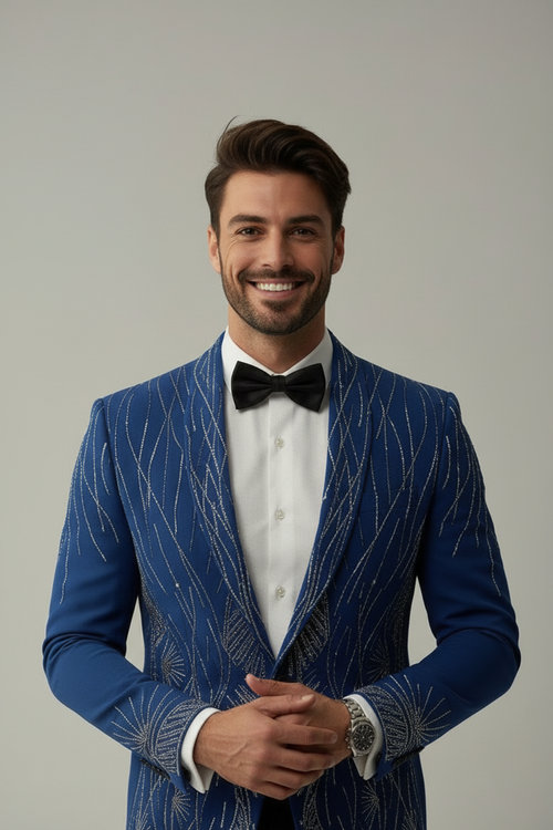 Man wearing a blue suit with a bow tie against a gray background