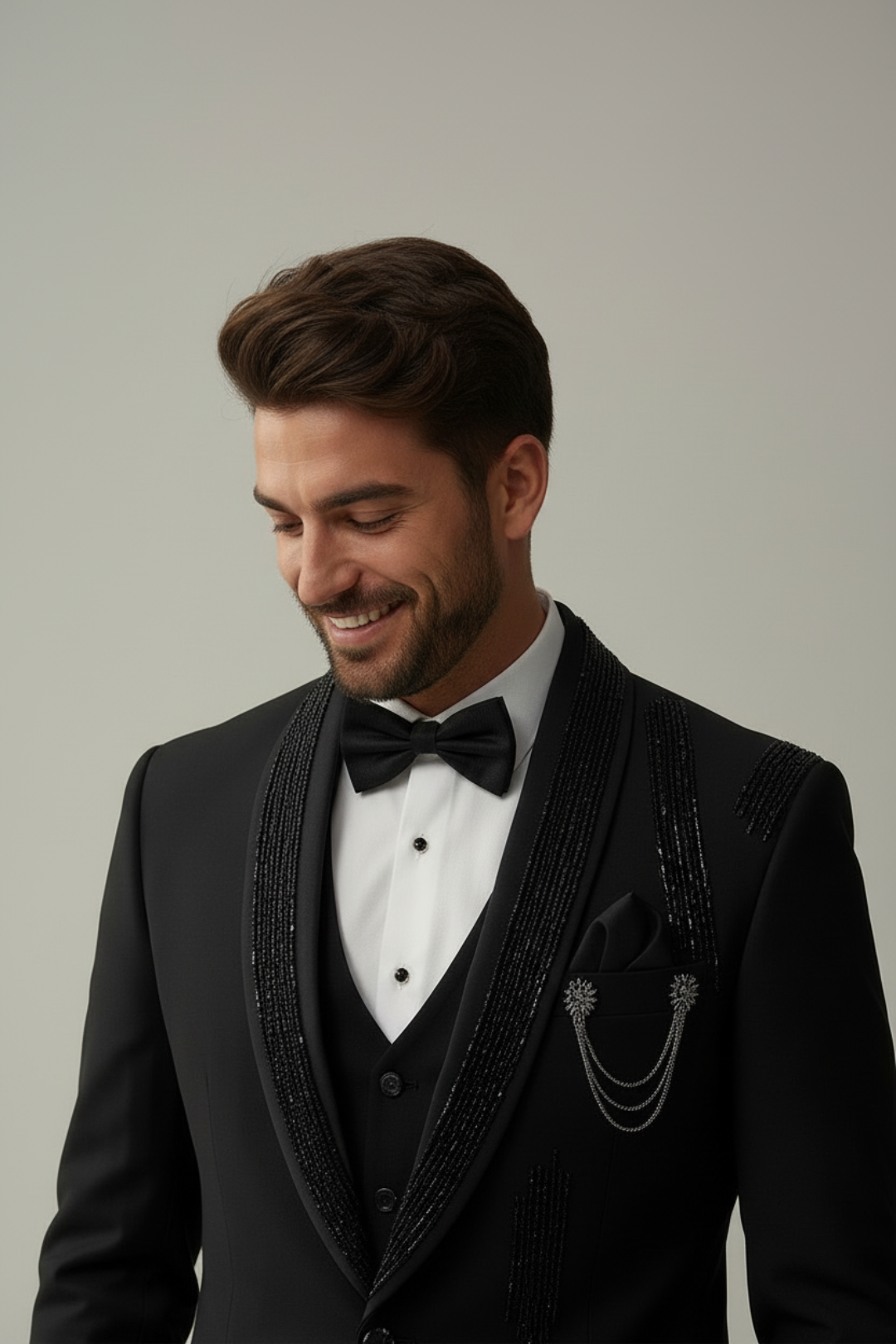 Man wearing a black tuxedo with a bow tie against a plain background