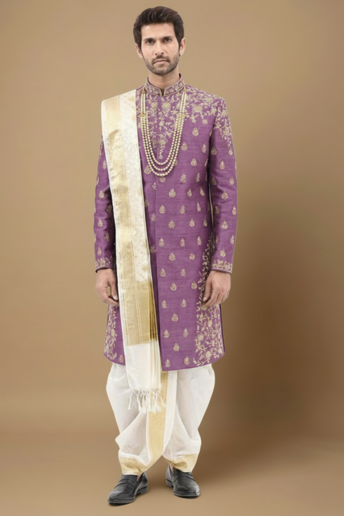 Man wearing a traditional purple and white sherwani with a beige stole on a brown background