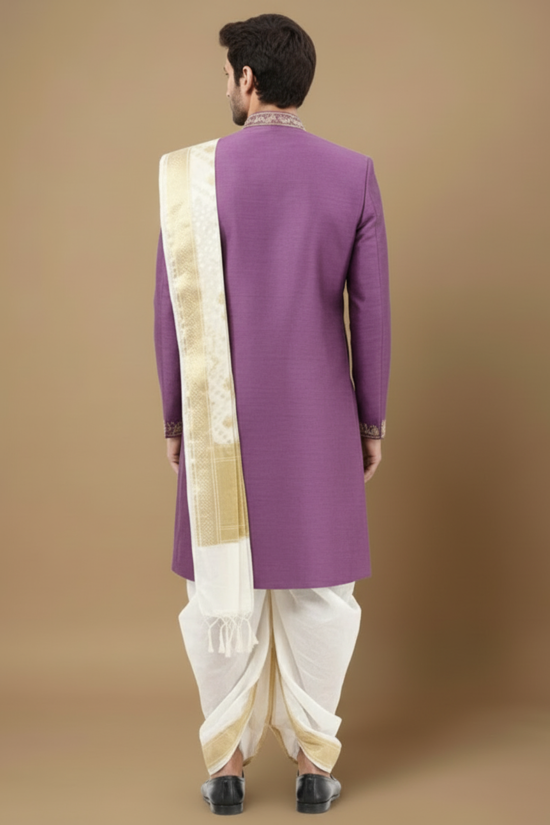 Man wearing a purple embroidered sherwani with a white stole against a beige background