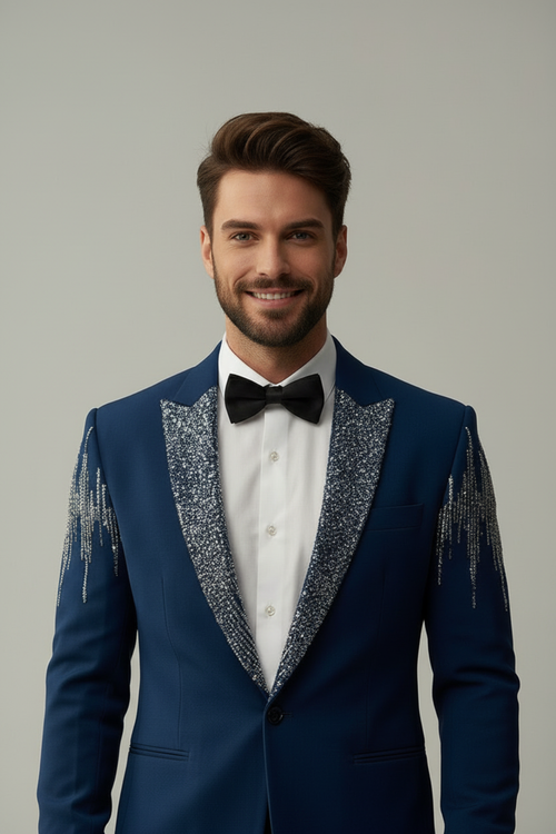 Man wearing a blue tuxedo with decorative lapels on a gray background