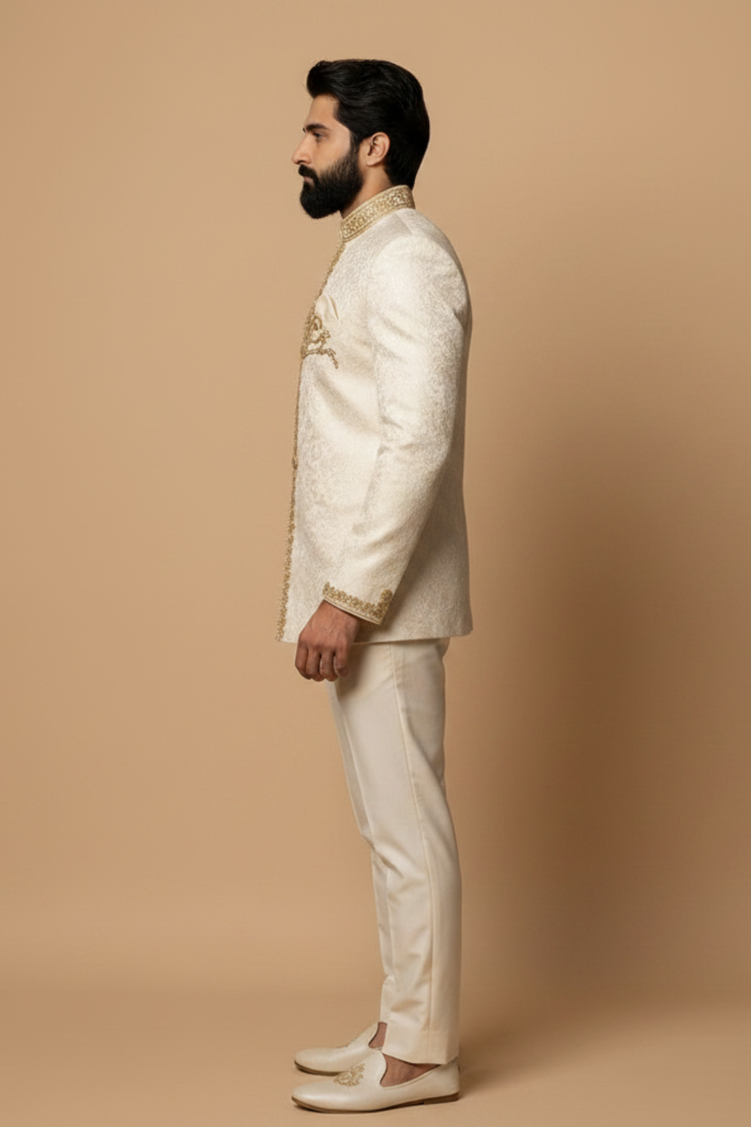 Man wearing a cream traditional outfit against a beige background