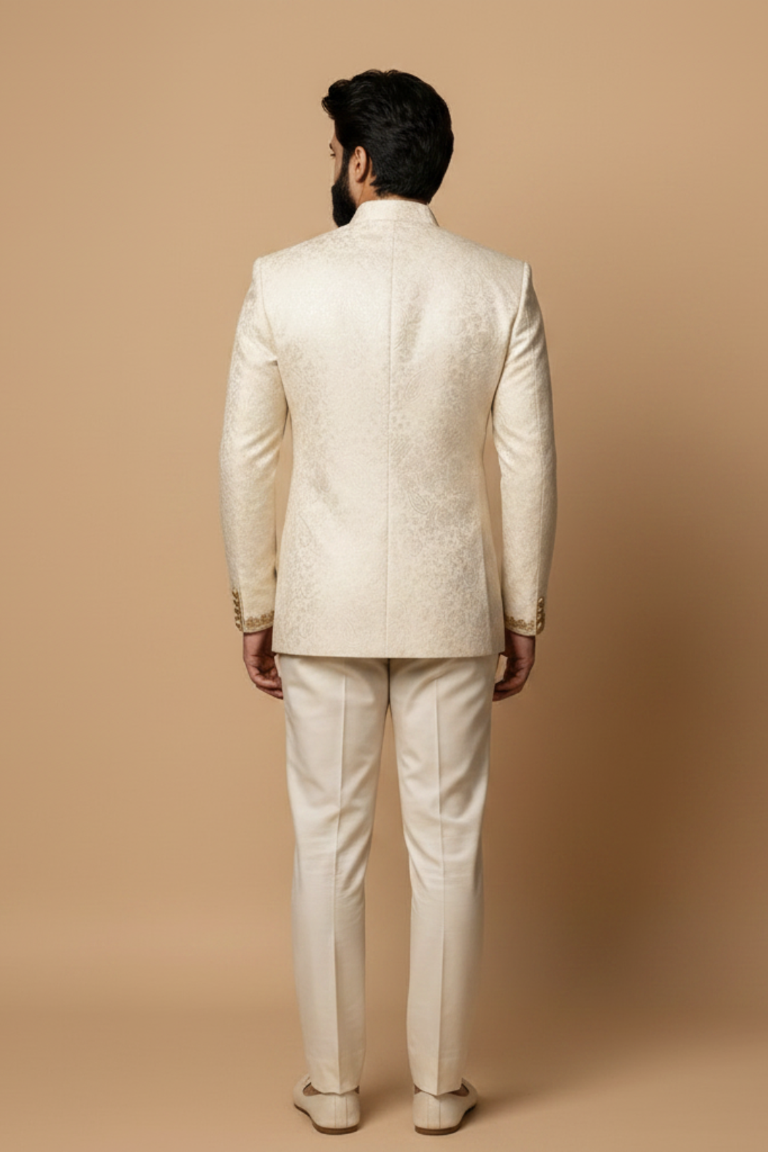 Man wearing a cream-colored suit against a beige background