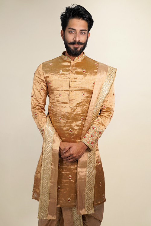 Man standing in gold zari pattu pancha set