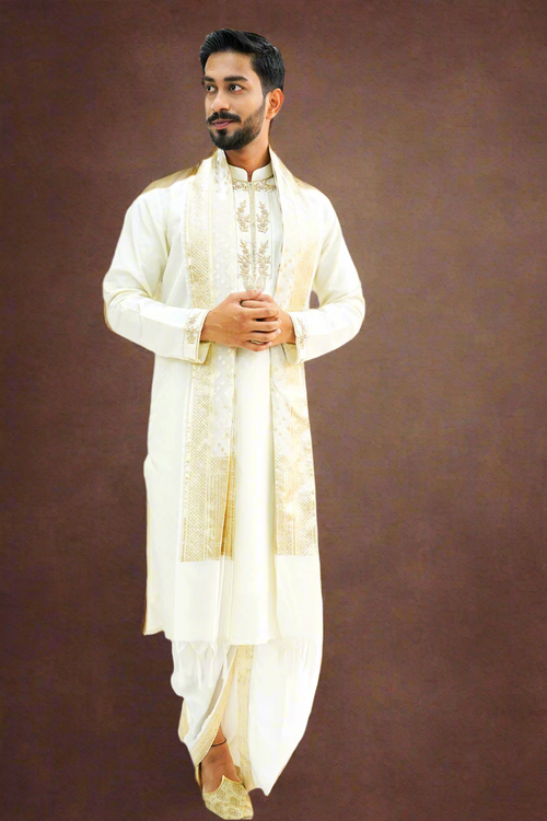 A man wearing a light cream textured pattu kurta with zardozi work. The kurta has long sleeves and features intricate embroidery.