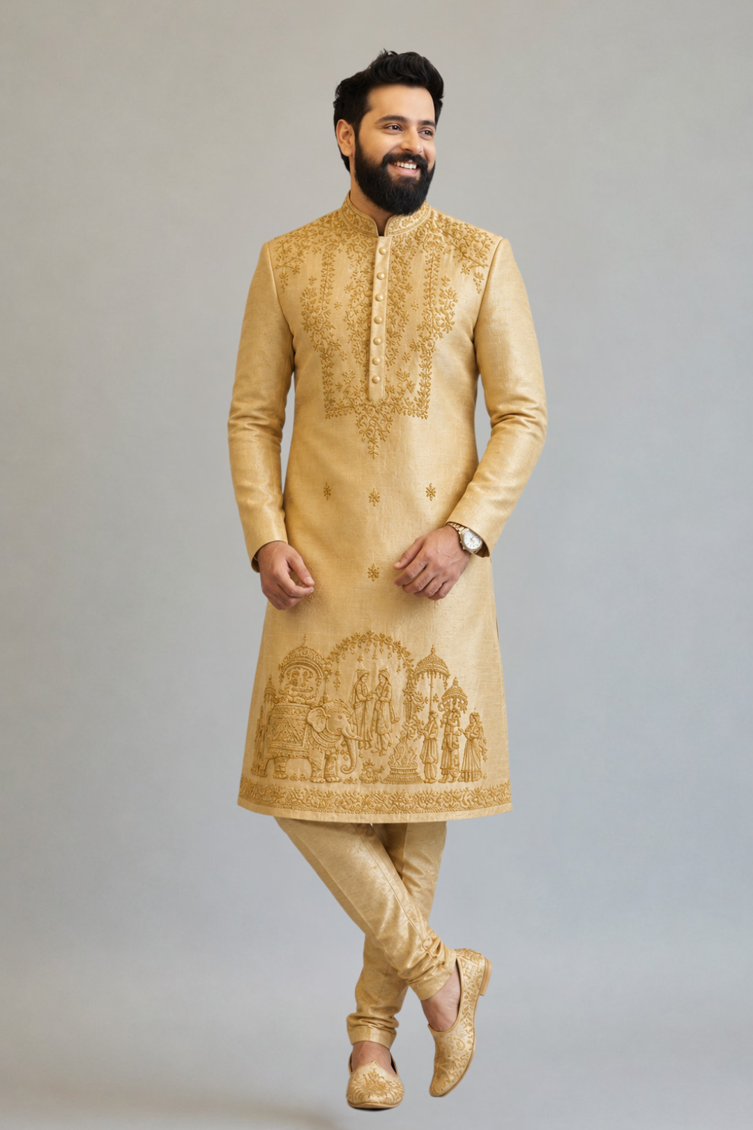 Man wearing a gold embroidered kurta with pants on a gray background