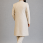 Man wearing a beige traditional outfit on a gray background
