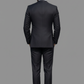 Man wearing a black suit on a gray background