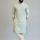 Man wearing a light green kurta with white pants against a plain background