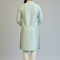 Man wearing a light green kurta with white pants on a plain background