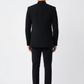 Man wearing a black suit standing against a white background