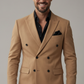 Man wearing a tan double-breasted jacket with a gray background