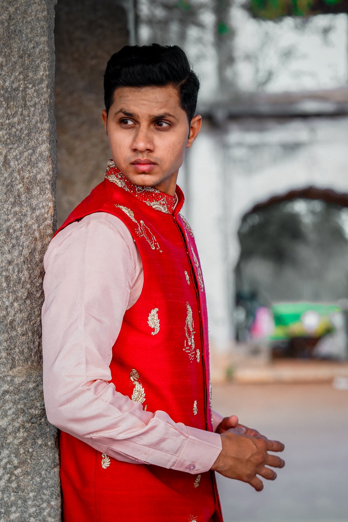 Men’s orange embroidered Indo-Western kurta set with pastel pink pants and white loafers for traditional ethnic wear styling