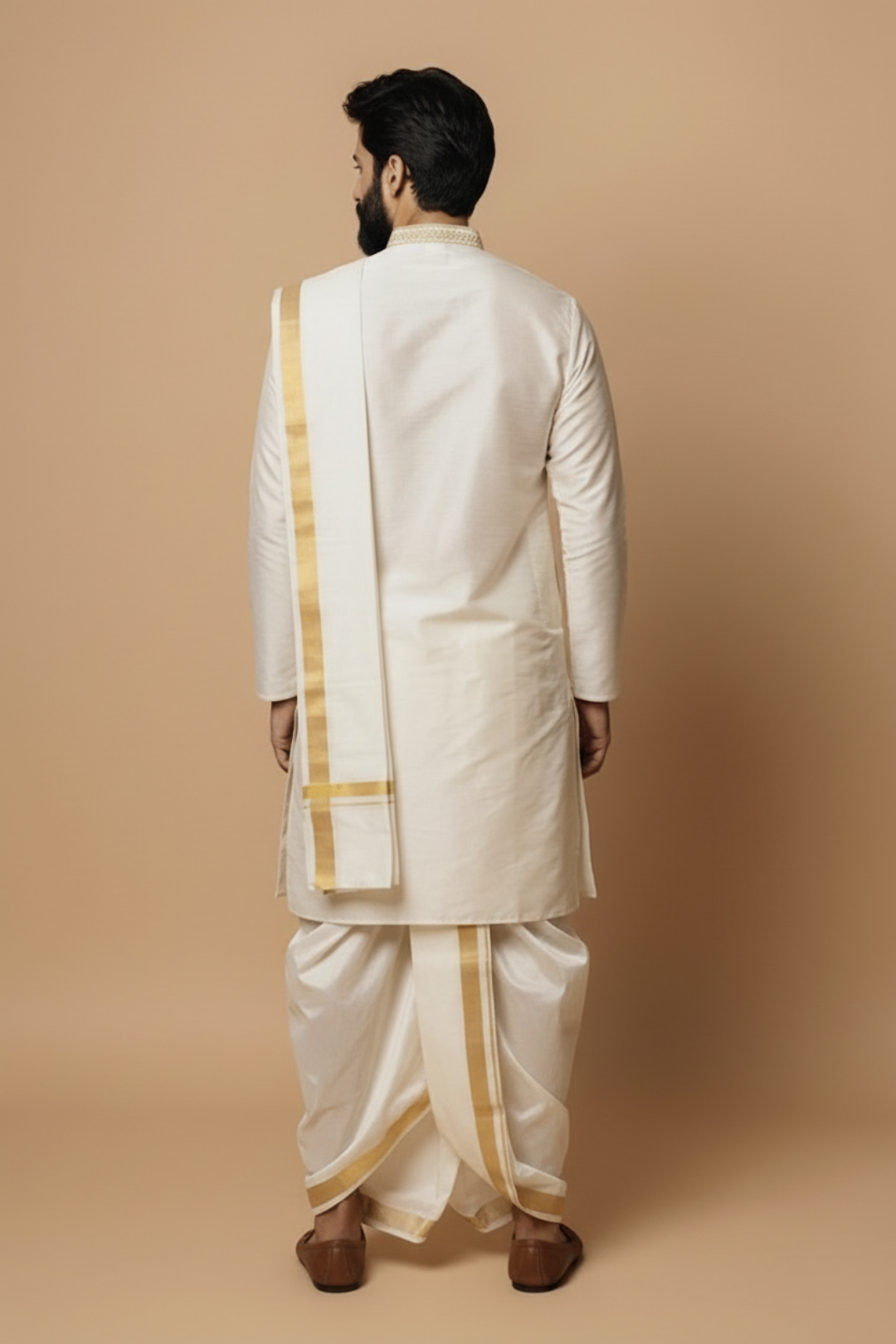 Man wearing a traditional white kurta with gold accents on a beige background