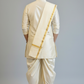 Man wearing a traditional cream-colored dhoti with a matching shawl on a gray background