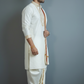 Man wearing a traditional white kurta with gold accents against a gray background