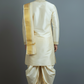 Man wearing a traditional cream kurta with a gold border against a gray background