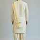 Man wearing a traditional cream-colored kurta with a white dhoti and gold border against a plain background