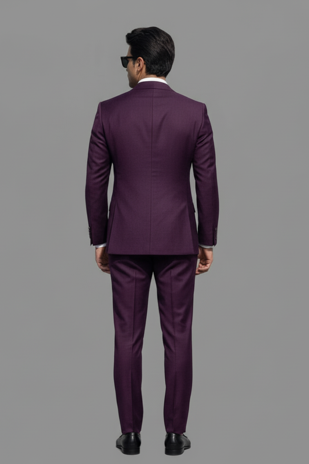 Man wearing a purple suit on a gray background