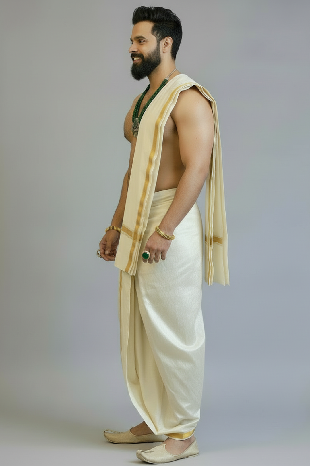Man wearing a traditional beige dhoti with a white background