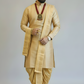 Man wearing a traditional beige kurta with a dhoti on a plain background