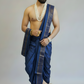 Man wearing a blue dhoti with a white background