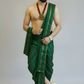 Man wearing a green traditional outfit with gold accents on a plain background